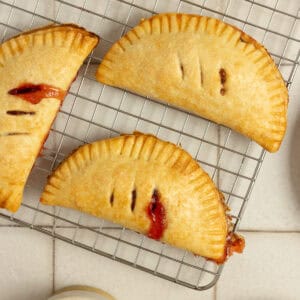 strawberry hand pies on a cooling rack.