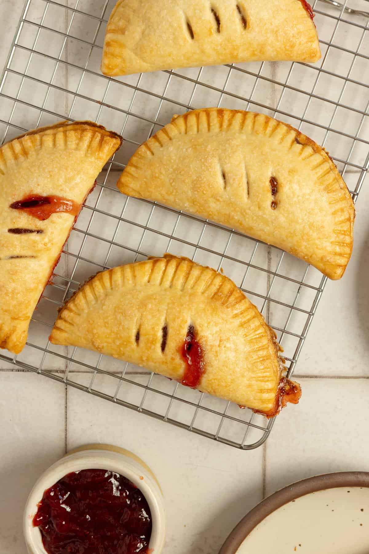 Strawberry hand pies on a cooling rack.