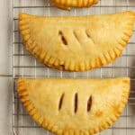 3 strawberry hand pies on a cooling rack.