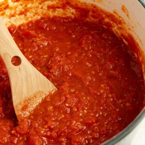 marinara sauce cooking in a dutch oven.