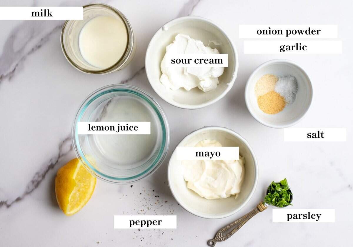 Lemon juice, mayo, sour cream, spices, and more on a marble countertop.