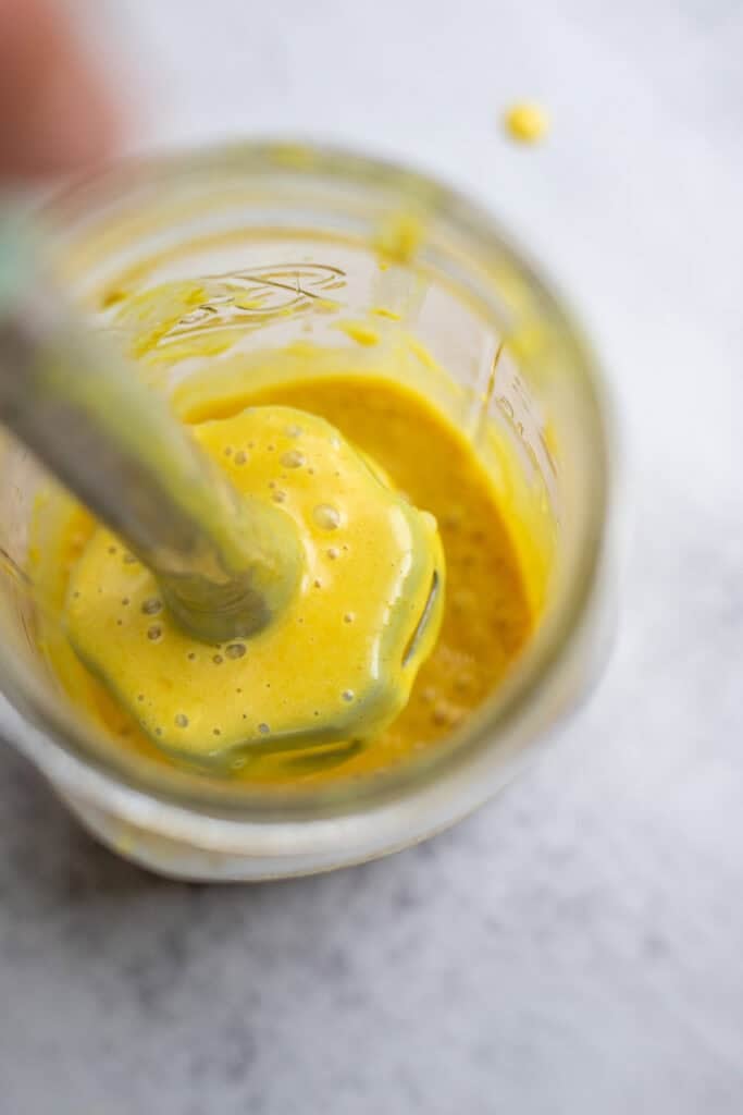 Blending up ingredients in a mason jar.