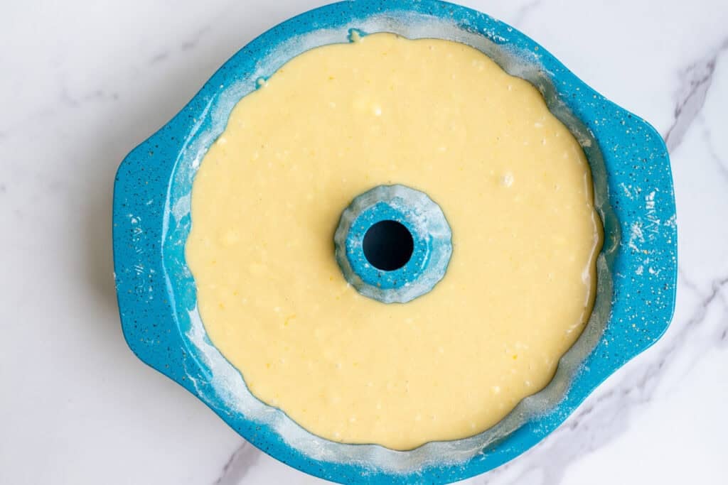 Sourdough Bundt cake batter poured into a prepared Bundt pan.