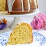 slice of sourdough bundt cake on a white and blue plate.