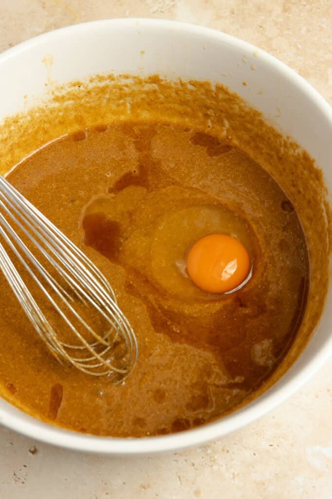 Egg yolk and vanilla added to bowl of wet ingredients.