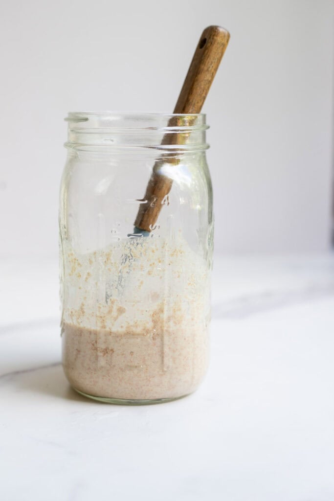 Half sourdough starter discarded and fed with flour and water.