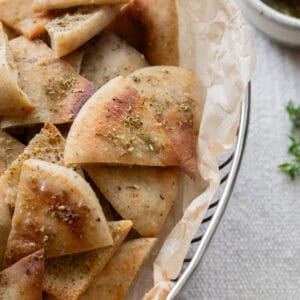 sourdough pita chips layered in a bowl.