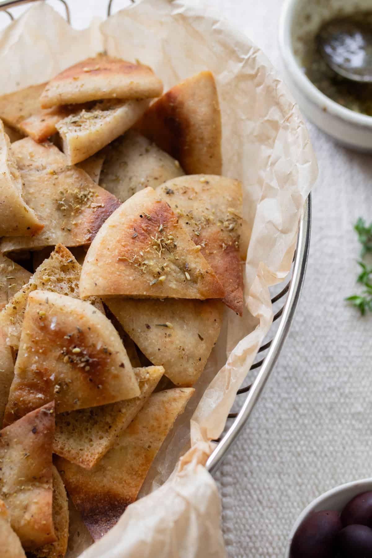 Sourdough pita chips layered in a bowl.