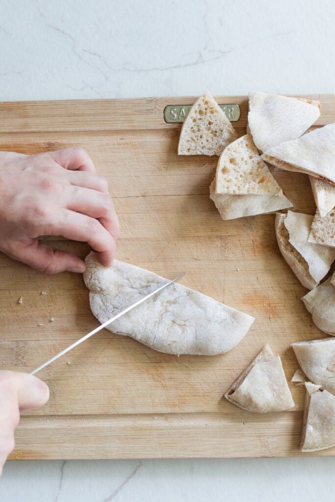 Cutting pita bread into 6 even triangles.