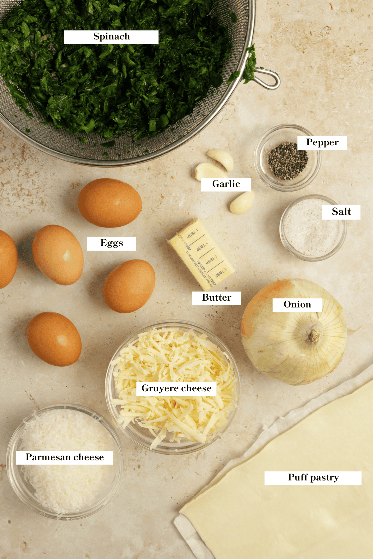 Ingredients for spinach pie laying on the countertop.