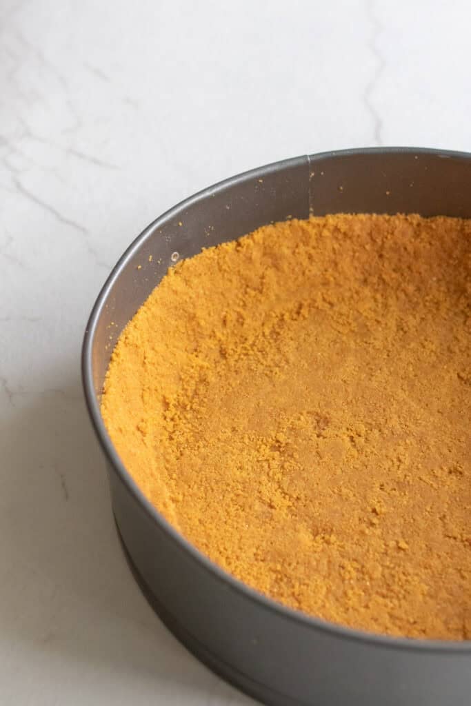 Graham cracker crust pressed into a pan.