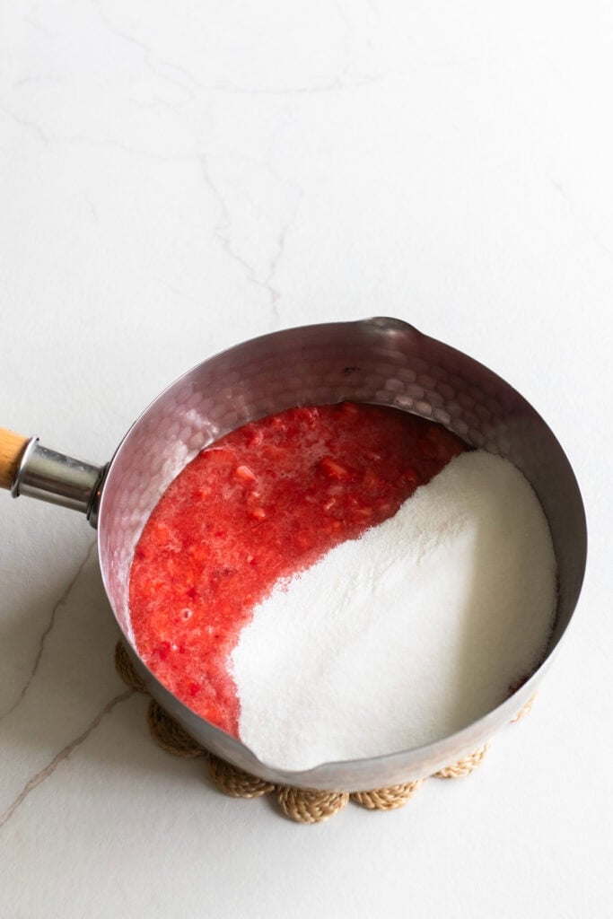 Blended strawberries and sugar in a saucepan.