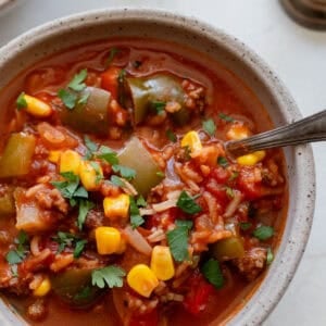 a bowl of soup on a marble countertop.