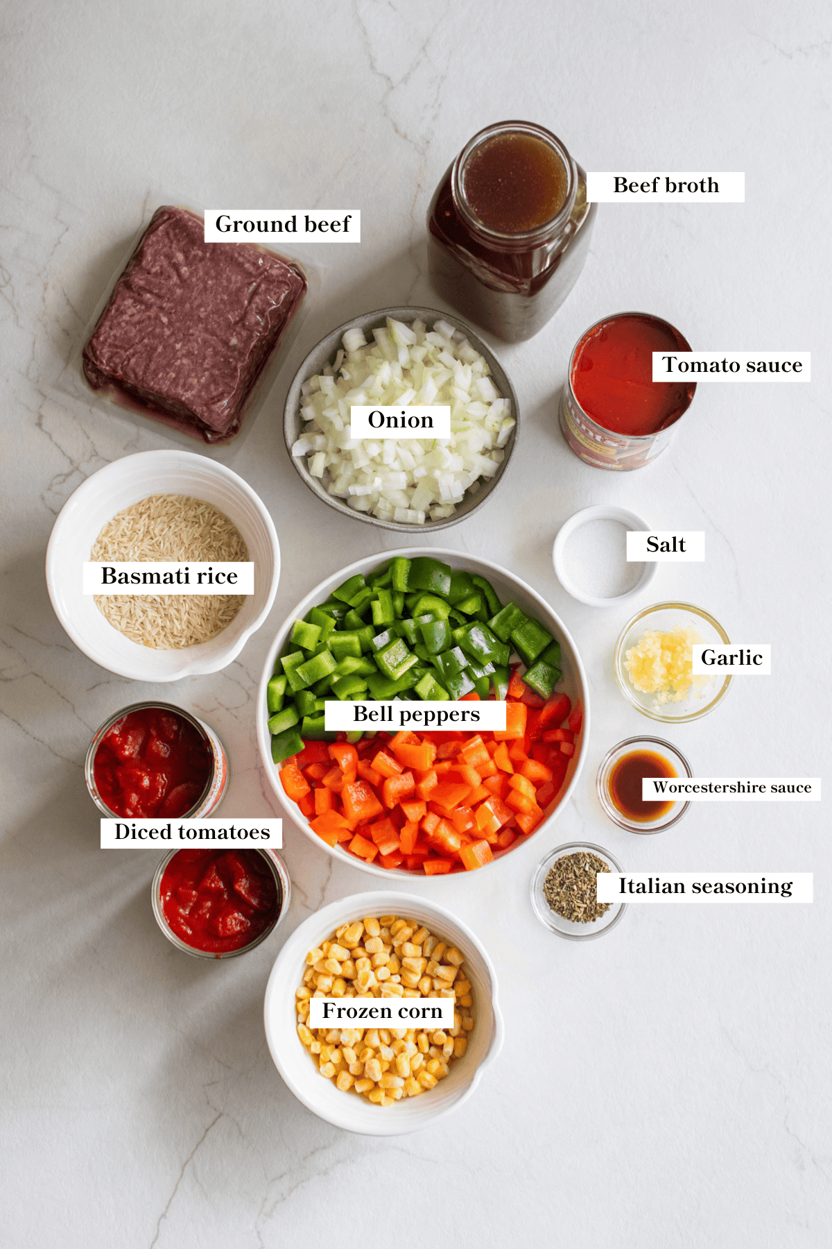 Ingredients in little bowls on a marble countertop.