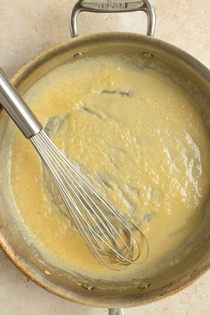 Making a gravy with flour and butter in a pan.
