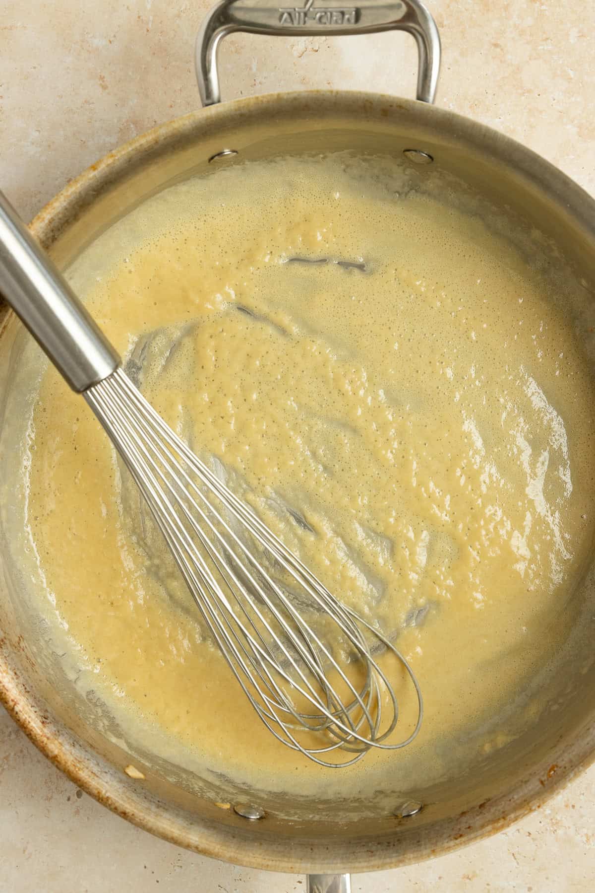 Making a gravy with flour and butter in a pan.