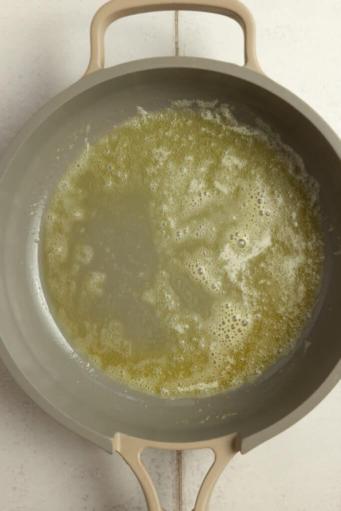 A hot skillet with melted butter in it.
