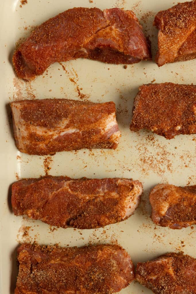Seasoned pork ribs on parchment paper.