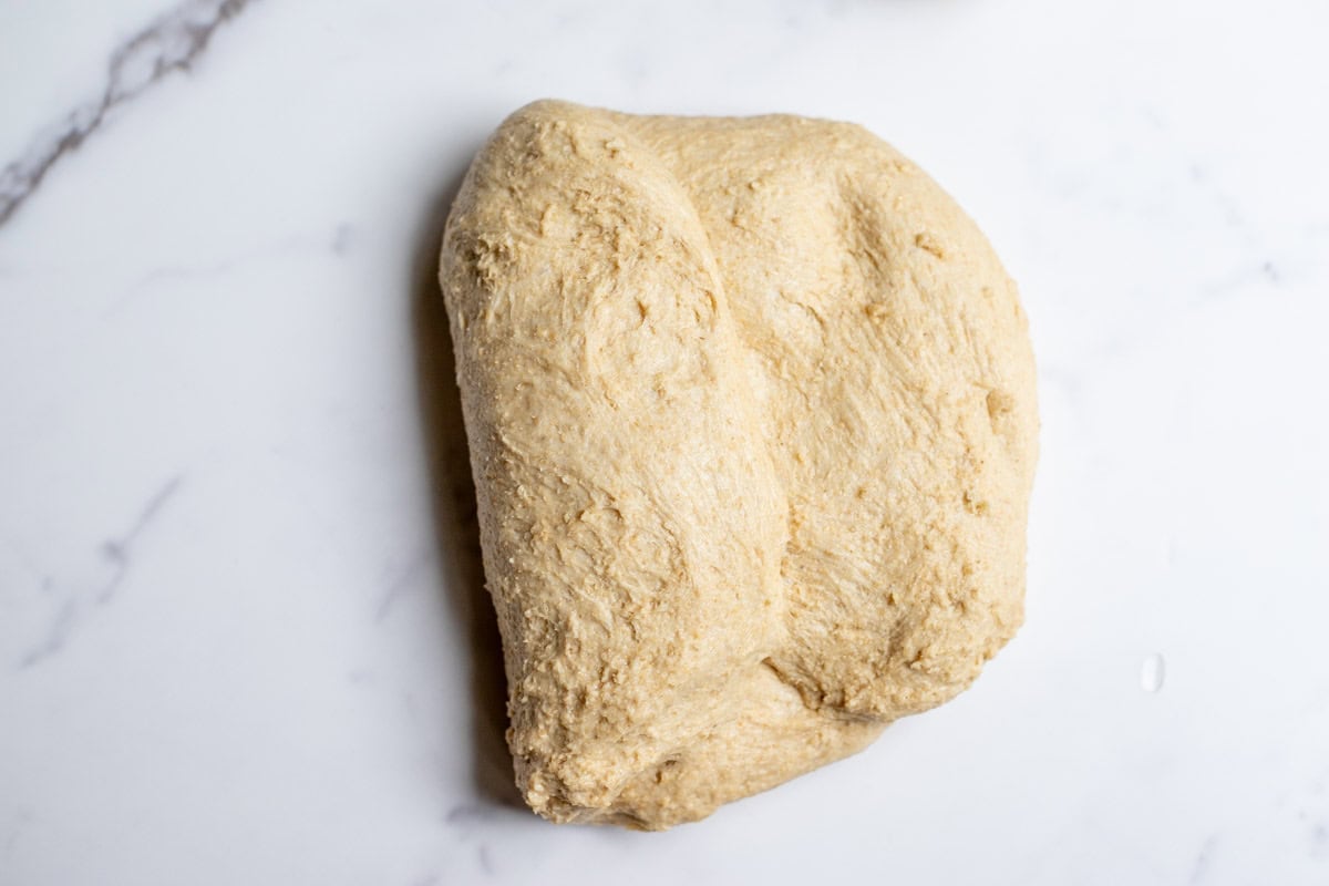 Shaping bread dough on a countertop.