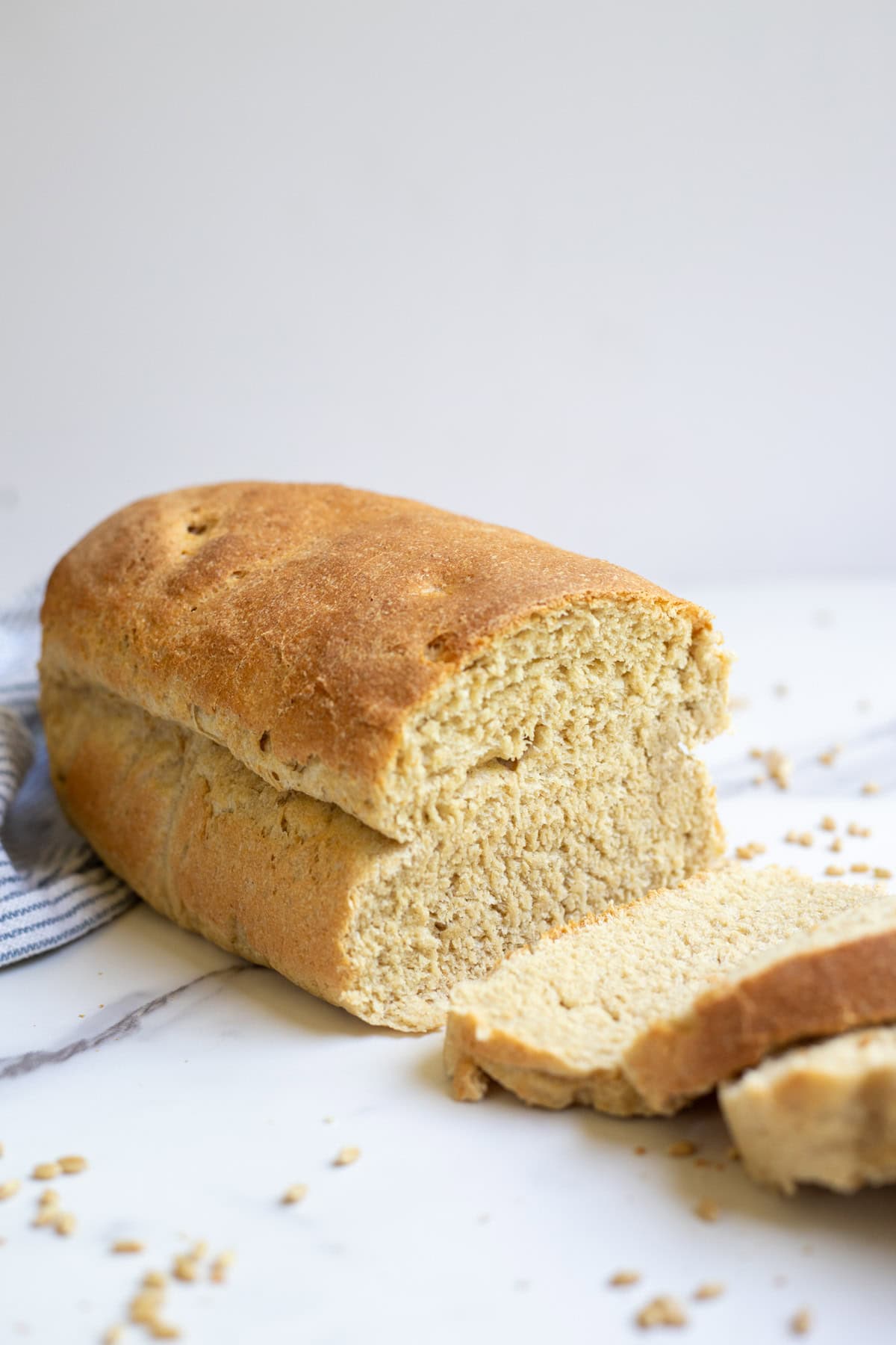 Fresh milled sourdough sandwich bread sliced up on a countertop.