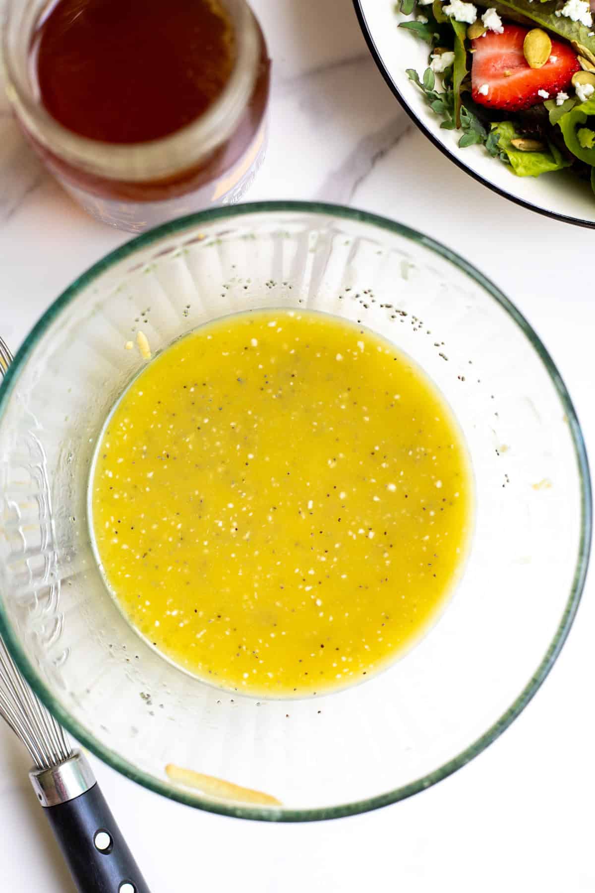 Poppy seed salad dressing whisked up in a bowl.