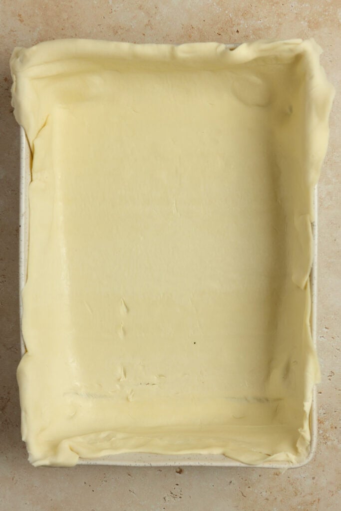 Puff pastry spread in a 13x9 baking dish.