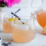 a glass of lavender lemonade sitting on the marble counter.