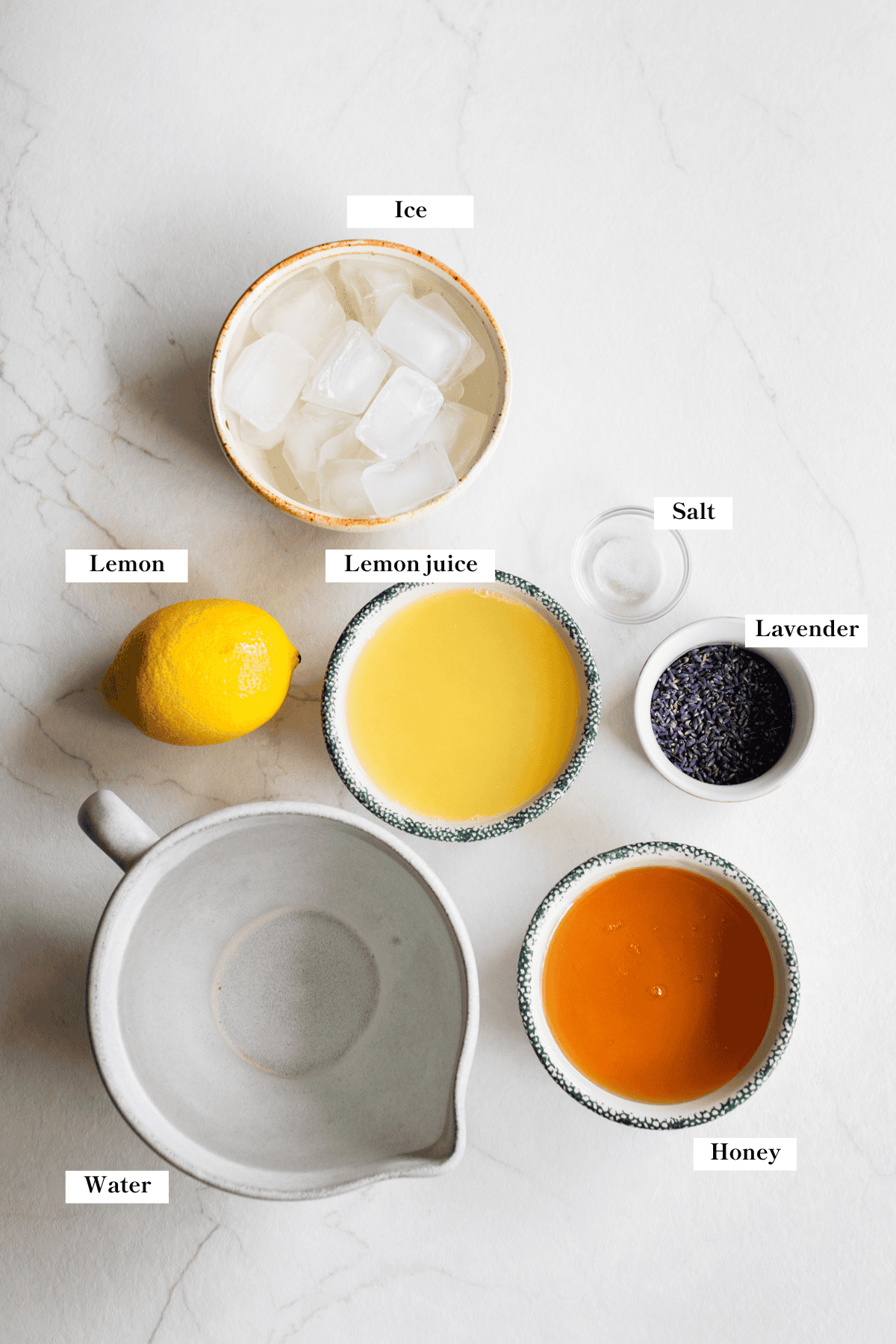 Ingredients to make lavender lemonade arranged on the counter.