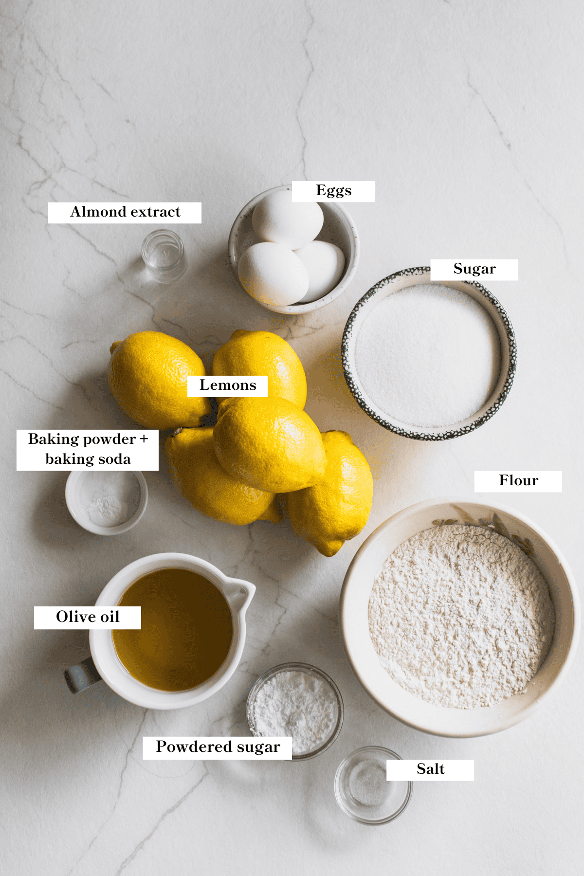 Ingredients for a lemon olive oil cake laying on the countertop.