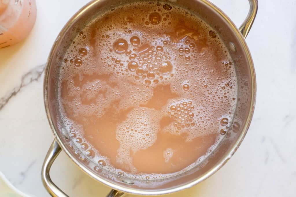 Peach juice simmering in a large pot.