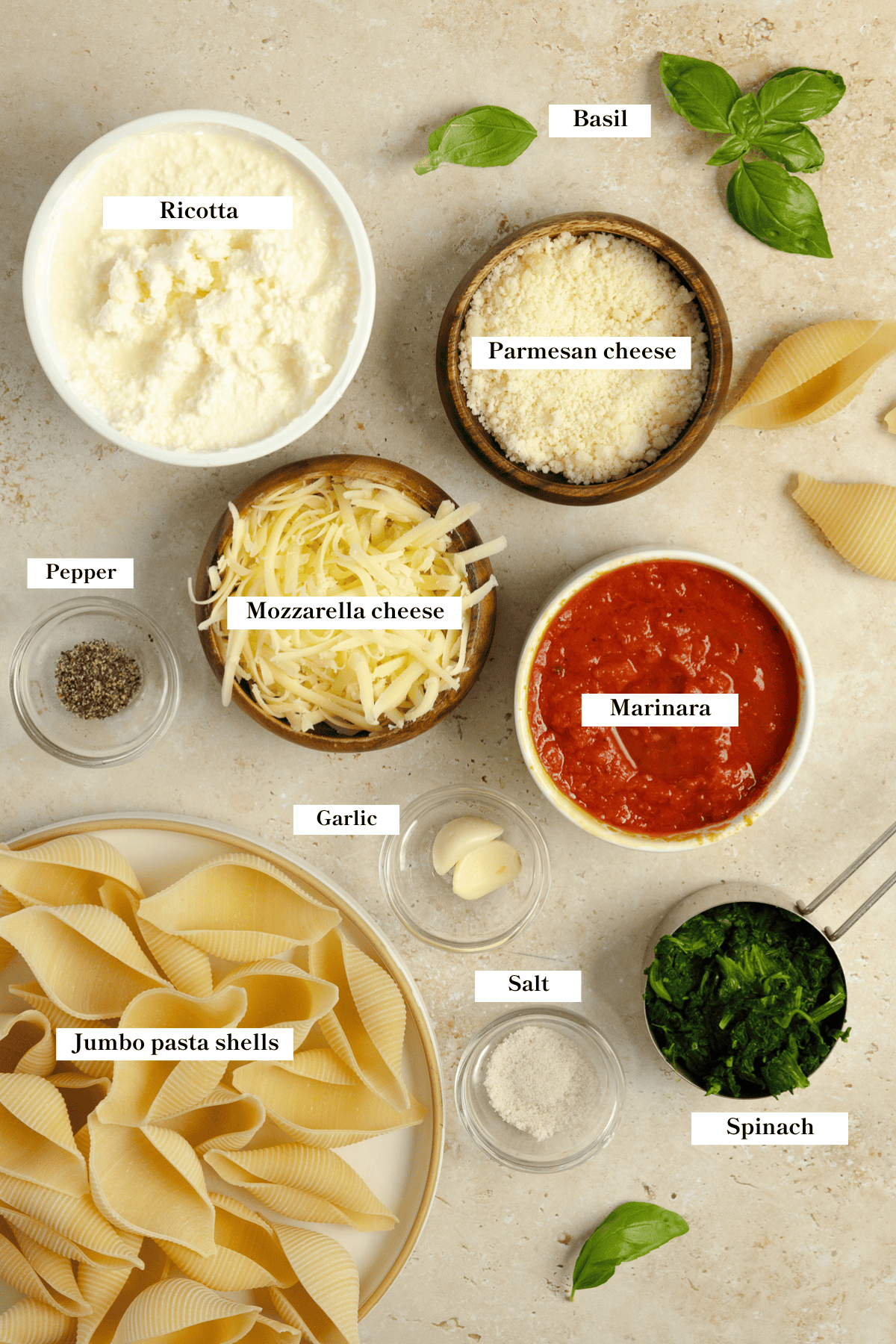 Pasta, spinach, ricotta, parmesan, mozzarella, and seasonings on the counter.