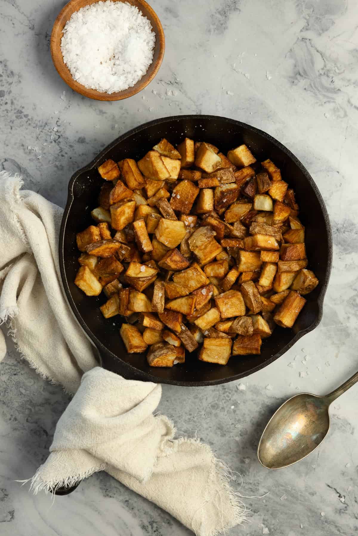fully cooked potatoes in a skillet on the countertop.
