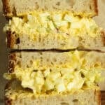an egg salad sandwich cut in half.