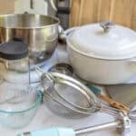 a variety of kitchen tools laying on the kitchen counter.