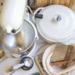 a kitchenaid mixer, dutch oven, and other baking tools on the counter top.