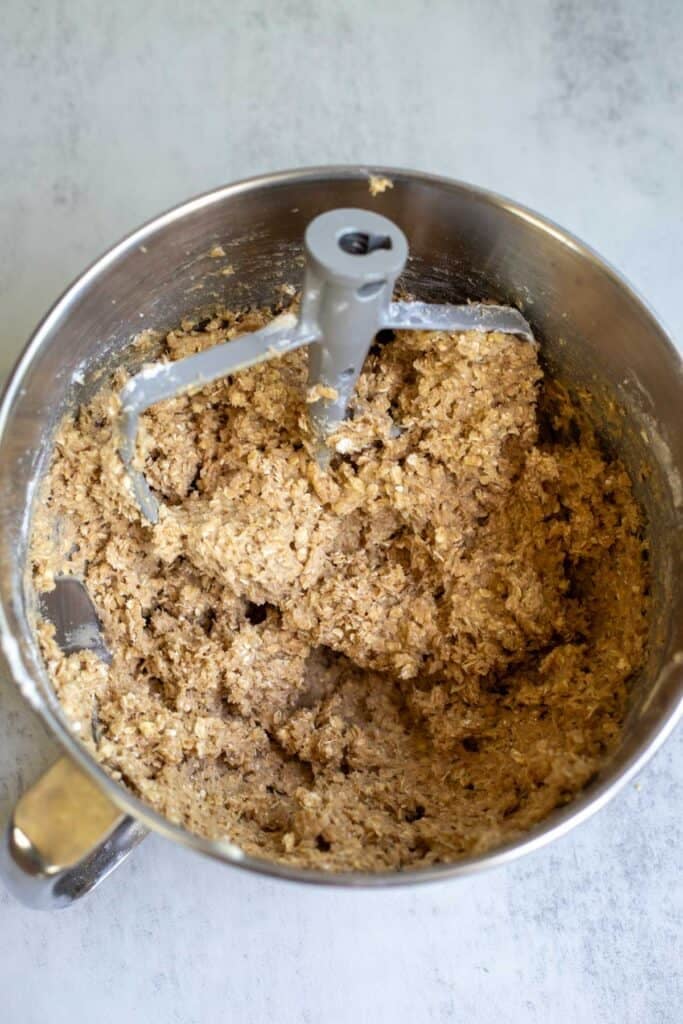 Oatmeal cookie batter in a stand mixer.