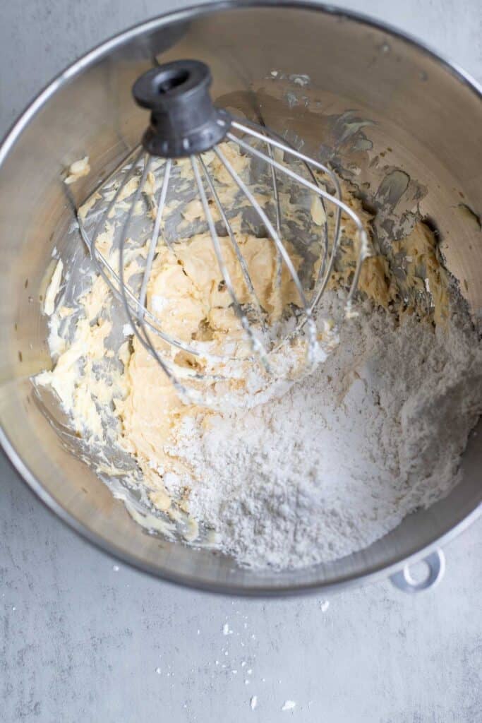 Powered sugar added to a cream cheese frosting batter.