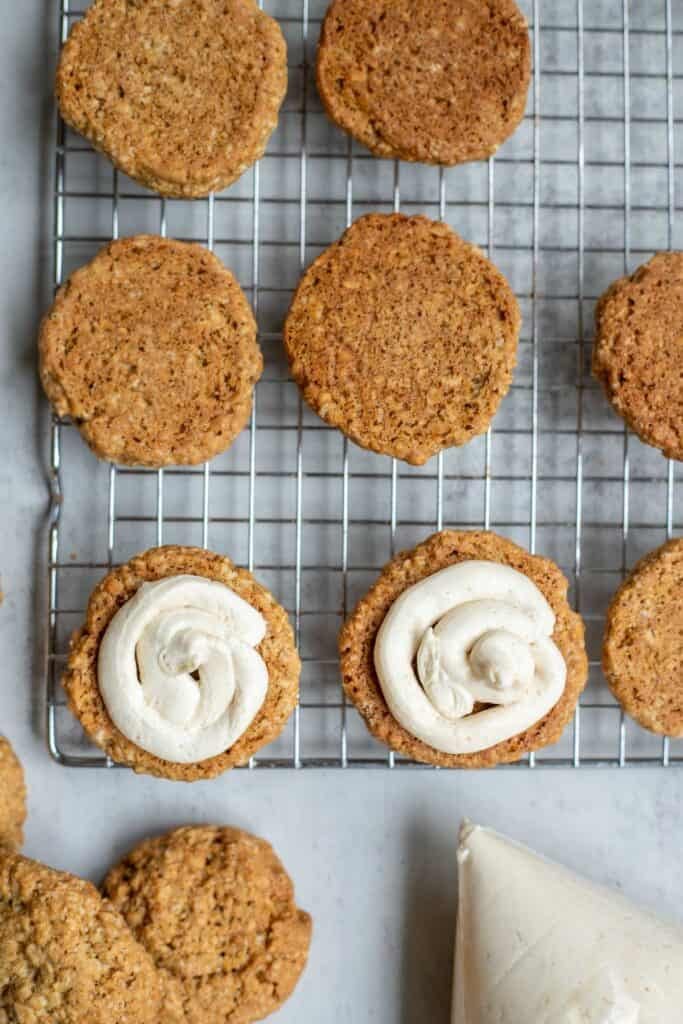 Piped cream cheese frosting on an oatmeal cookie. 