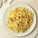 a plate of pasta sitting on a kitchen counter.