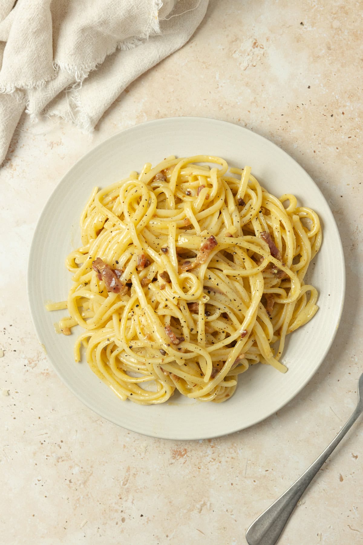 A plate of pasta sitting on a kitchen counter.