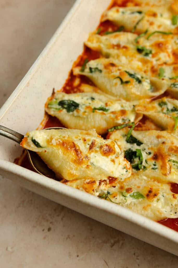 Fully cooked pasta shells stuffed with ricotta cheese and covered with marinara sauce.