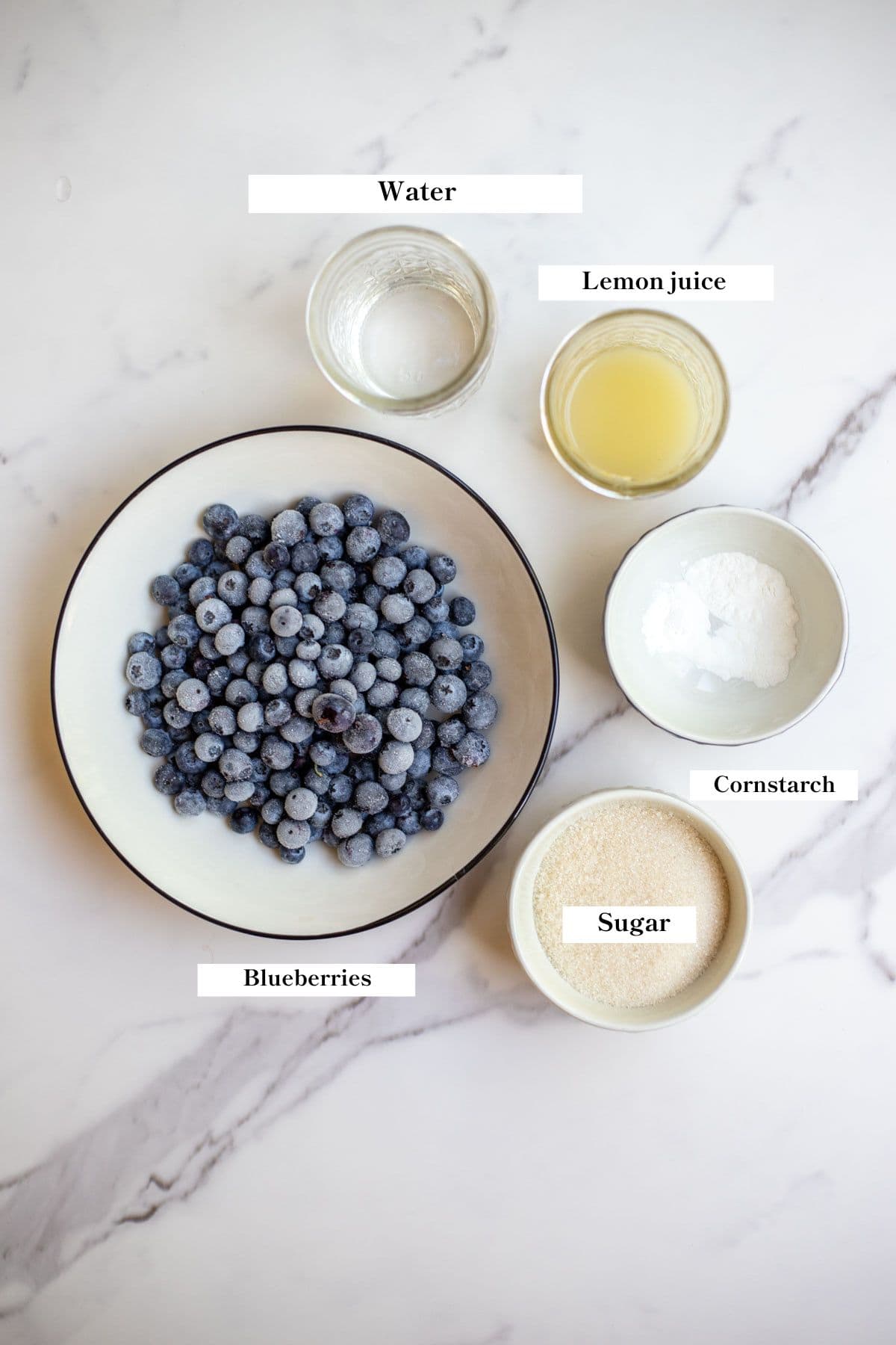 Blueberries, cornstarch, sugar, lemon juice, and water on the counter.
