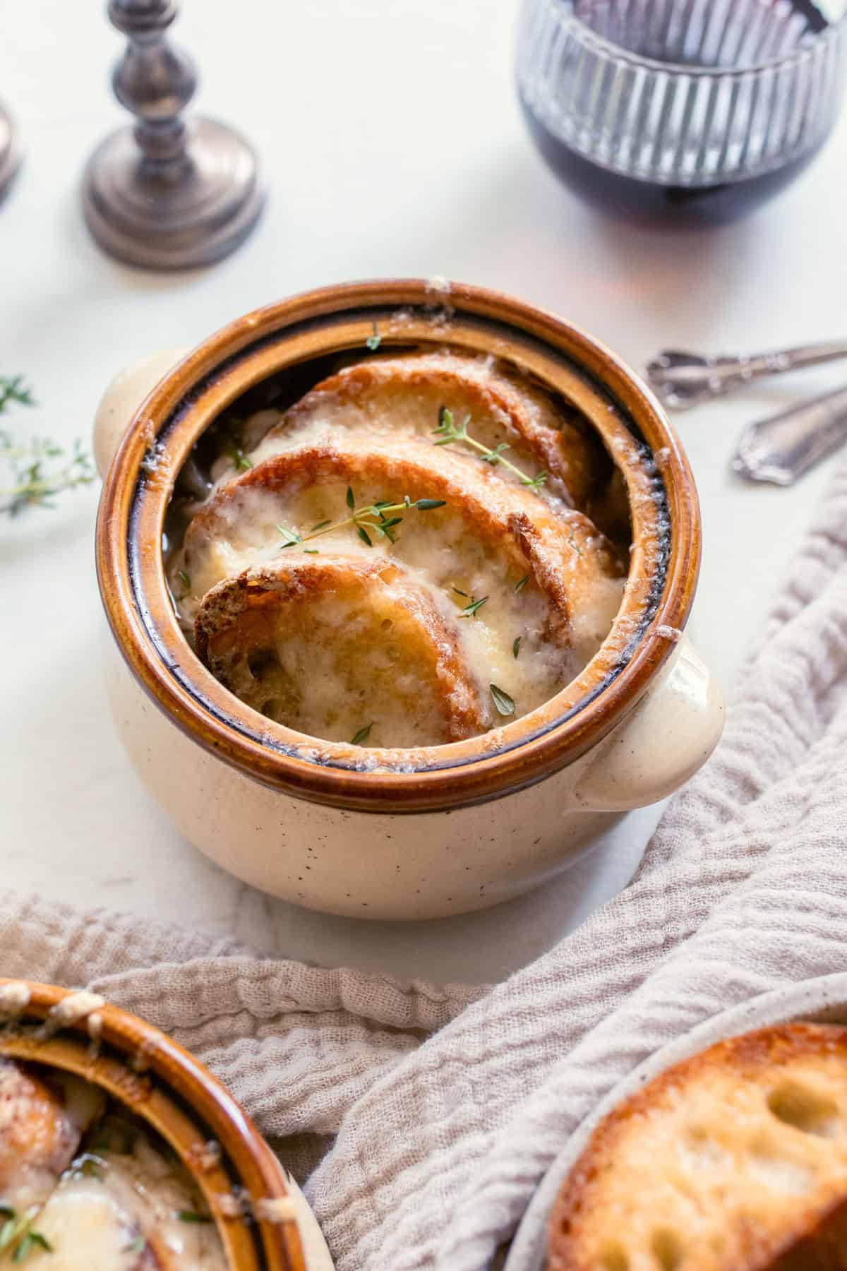 French onion soup topped with baguette slices and melted cheese.