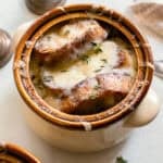 french onion soup with fresh bread in a crock pot.