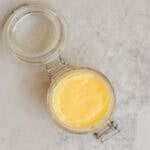 an open glass jar filled with homemade ghee.