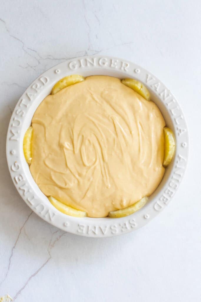 Unbaked pineapple upside down cake in a pie plate. 