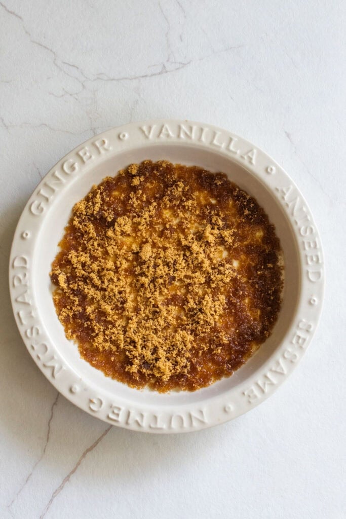 Brown butter with brown sugar and cinnamon in the bottom of a pie plate.