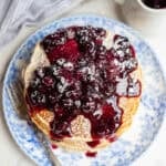 blueberry covered ricotta pancakes on a plate.