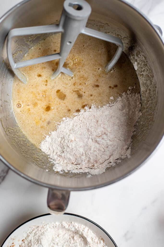 Dry ingredients added to wet ingredients to make a cake.
