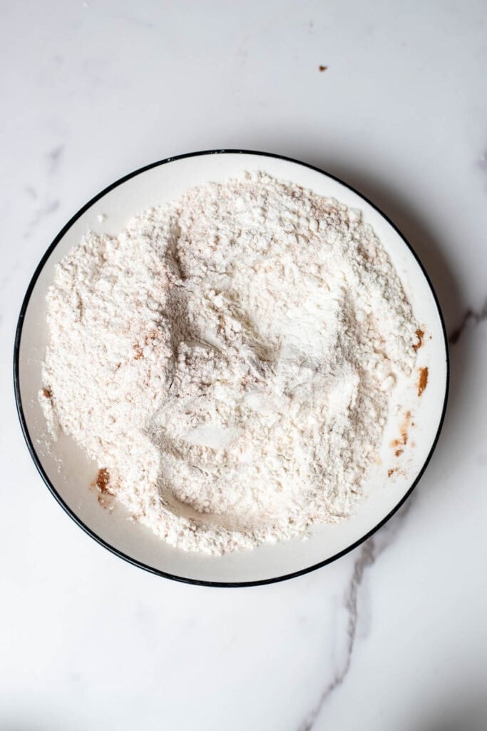 Dry cake ingredients in a bowl, mixed together.